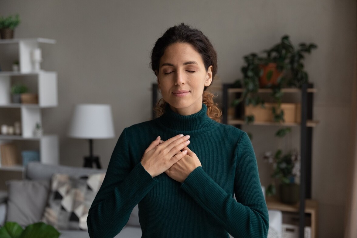 Depth therapy and trauma healing image — woman with hands over heart representing inner connection and emotional release