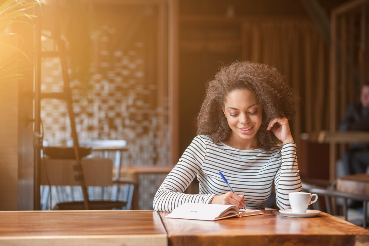 Therapy concept image — woman writing in a journal to support emotional healing and self-reflection