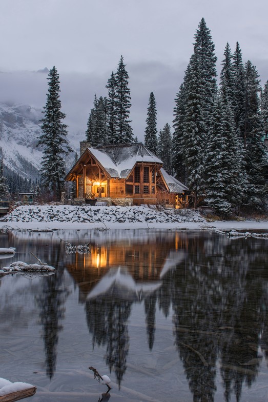A quiet winter cabin surrounded by snow, reflecting rest, stillness, and emotional slowing during the winter season